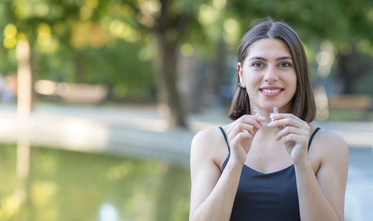 Female Patient smiling with Invisalign aligners
