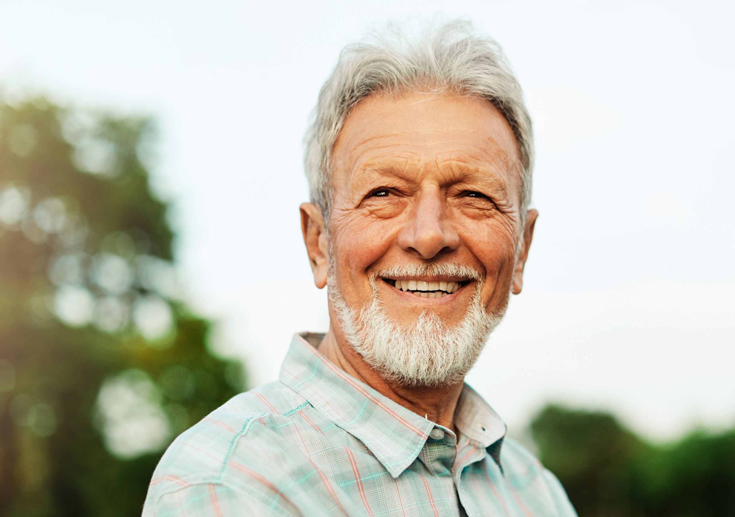 A Man Smiling After Receiving Dental Restorations